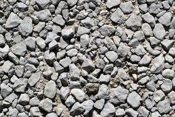 Top view of gravel. Gravel texture. Pebble stone background. Light grey small rocks. Top view of ground gravel road.
