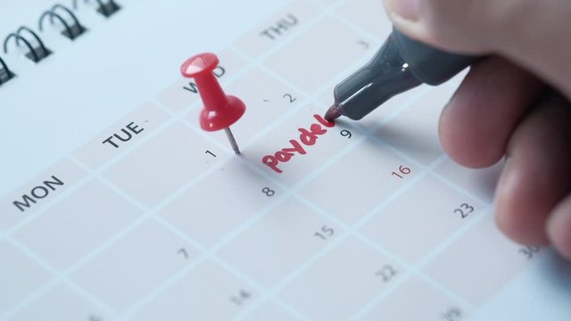 Close up of pay debt word on calendar