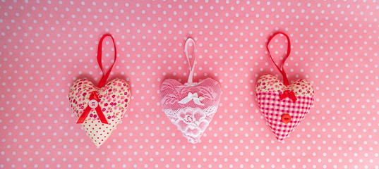fabric hearts on a pink background