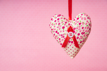 fabric hearts on a pink background
