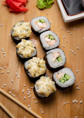 Rice rolls with smoked chicken and garlic sauce. Wood background. Photo for the menu