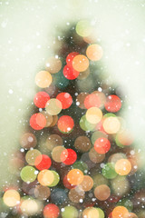 Christmas tree background with snowfall and bokeh lights