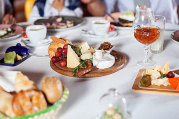 cheese plate on a wooden stand, which stands on a table