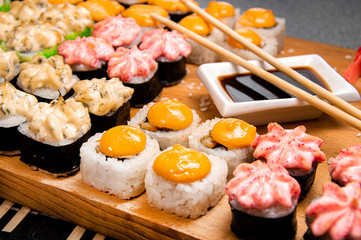 Set of baked roll. Cup with soy sauce. Chinese sticks. Photo for the menu.