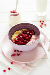 Breakfast with strawberry and banana smoothie bowl on white background. Healthy food concept. Flat lay. Top view