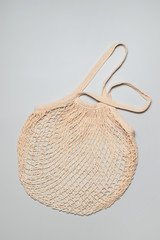 Reusable bag on a gray background. Environmental concept, zero waste. Caring for the environment, rejection of plastic