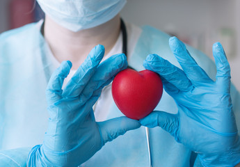 Healthcare and medical concept. Covid-19. Female doctor holding red heart shape