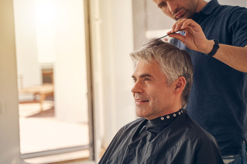 Handsome Caucasian man smiling and looking thoughtfully