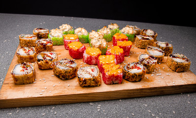 Seth of baked roll with sauce on a wooden surface. Rice on the background