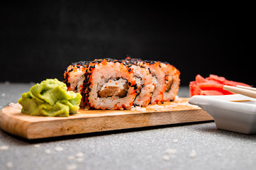 Orange rolls with black sesame seeds. Wood surface. Photo for the menu