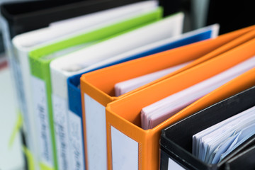 Document binder file folders stack on office desk in organization with report paper, paperwork record label, A lot of work information for businessman or lawyer organized archive database bookkeeping