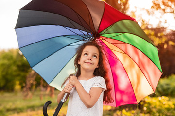 Dreamy girl with colorful umbrella