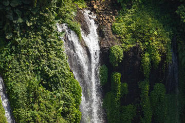 Naklejka na ściany i meble Close-up of the fresh and intense falling water in Tumpak Sewu Waterfall, in East Java, Indonesia.