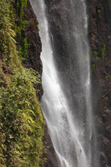 Close-up of the fresh and intense falling water in Tumpak Sewu Waterfall, in East Java, Indonesia.