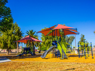 Two Sets Of Playground Equipment With Canopies