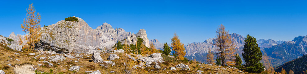 Fototapeta na wymiar Sunny picturesque autumn alpine Dolomites rocky mountain view from hiking path from Giau Pass to Cinque Torri (Five pillars or towers) rock famous formation, Sudtirol, Italy.