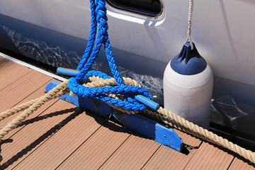 Fototapeta premium Mooring lines are wound on the bollards, bitengs, on the pier, the ships in the Marina are safe. The concept of safe navigation.