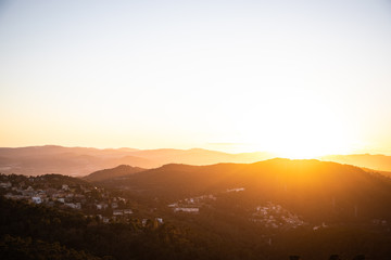 Beautiful sunset with sun rays with hills silhouette