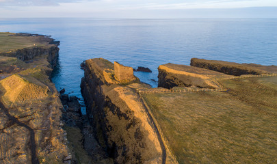 sunset on Old Wick Castle circa 1100 sits on a dramatic ancient coastline

