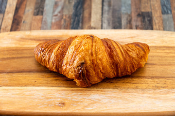 Delicious fresh croissant on table