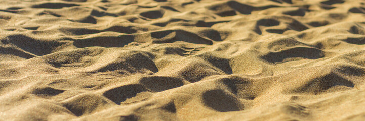 Closeup of sand pattern of a beach in the summer