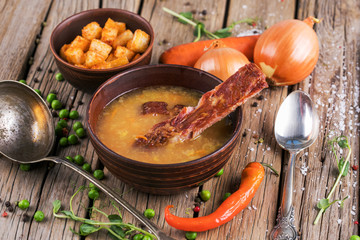 Pea soup with bacon on wooden boards