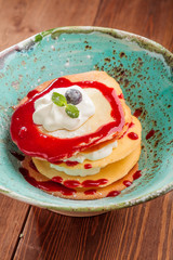 Original thin tulip dough dessert with airy mascarpone cream, fresh berries and raspberry sauce