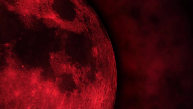A close-up of the turbulent atmosphere surrounding a red planetary moon.