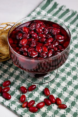 dogwood jam. Nearby are two baked goods in a wicker basket. fresh dogwood lies everywhere