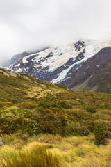 Valley in the Southern Alps among snow-capped mountains and hills. South Island, New Zealand