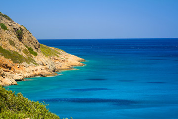 Fototapeta na wymiar Turquise water of Mirabello bay at the coastline of Crete, Greece