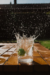 green apple splashing in a jar