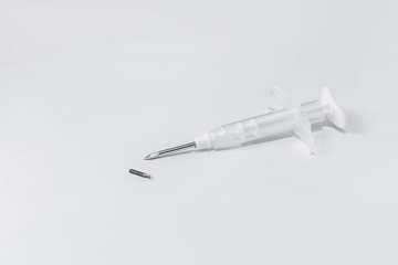 syringe with a microchip on a light background, no one, close up