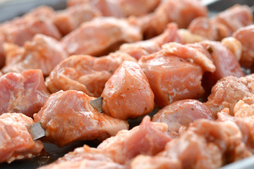 Raw meat on a metal skewer. Pork kebab close up. Soft focus