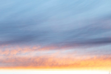 beautiful sunset colored clouds in a light haze on the sky.