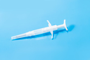 Fototapeta na wymiar syringe with a microchip on a blue background, chipping,nobody, close up