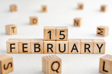 February 15 - from wooden blocks with letters, important date concept, white background random letters around