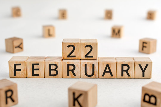 February 22 - from wooden blocks with letters, important date concept, white background random letters around