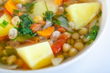 Fresh vegetable soup made of pea, carrot, potato and other vegetables