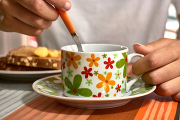 girl drinking coffee from flower cup