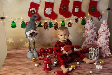 a little boy holding a toy at home . new year. a child on Christmas morning