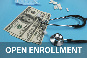 Open enrollment, medicine concept. Stethoscope, money and money on a green background..