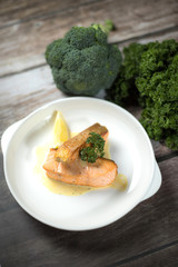 Salmon Steak.Grilled salmon with yellow cream sauce and asparagus on a white plate