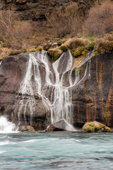 Obraz premium Hraunfossar waterfall cascade in the Reykholt area in Iceland. Travelling, nature and holiday concept.