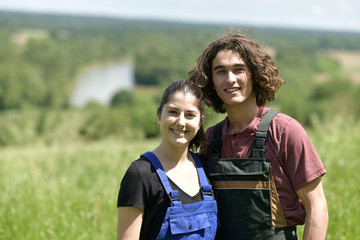 Young couple spending green vacation at the farm