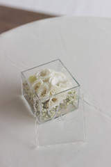 Wedding decoration - small rose flowers in a glass casket