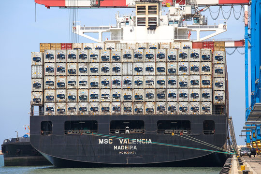 Large Container ship loaded with stacks of refrigerated containers.
