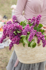 Walk with a basket of lilacs in the hands. Floristics
