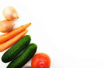 Vegetables onion, tomato, cucumber, carrot on a white background with a copy place