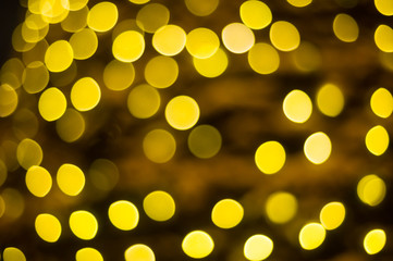 Abstract blurred background of yellow garland lights, bokeh. Christmas.